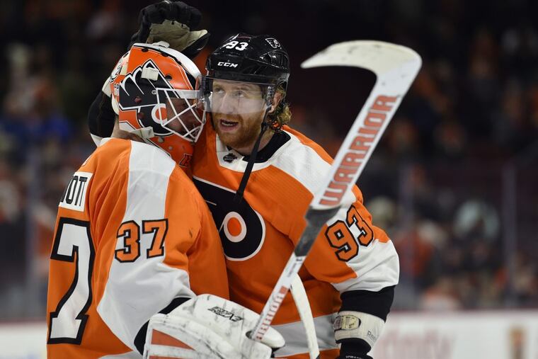 Flyers goalie Brian Elliott (left) and Jake Voracek are among the players receiving good grades for the team’s up-and-down first half of the season.