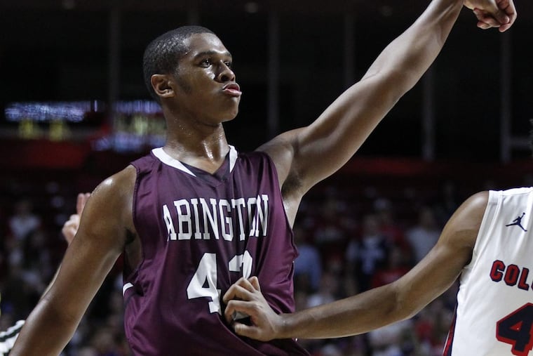 Eric Dixon (center) of Abington holds the pose after hitting a 3-pointer against Plymouth Whitemarsh in the district semifinals in February.