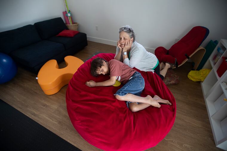 Luke DeFilippo, 20, survived 18 years with an inoperable brain tumor that left him developmentally like a toddler. As it became more and more difficult for his parents to manage his care, his South Jersey community rallied to raise the funds to renovate their home to make it more possible. They are holding an open house to thank those who helped. Luke is shown with his mother, Laura, in the new addition to their home.