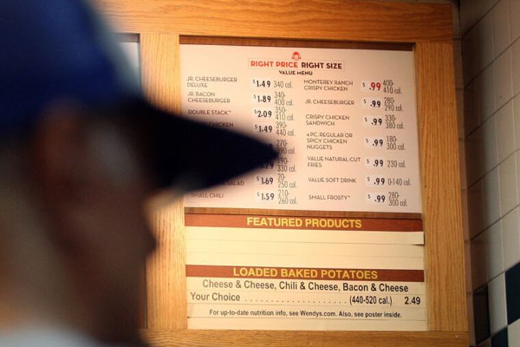 Customers order at Wendy's in Burbank, California, on September 26, 2013. In January, Wendy's 99-cent bargain menu transformed into Right Price Right Size and includes items costing as much as $2. McDonald's and other chains are also ditching the traditional dollar deal. (Cheryl A. Guerrero/Los Angeles Times/MCT)
