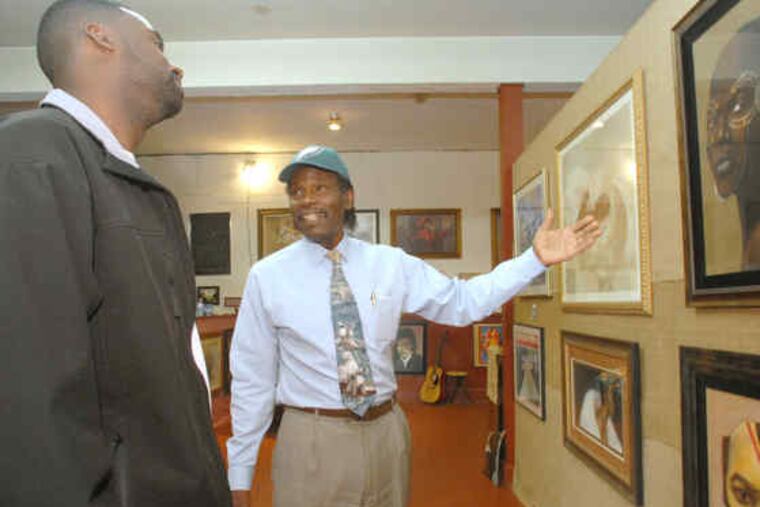 The Rev. Al Stewart (right) with gallery visitor Ed Long of Woodlynne. "People come in and say, 'Wow,' " Stewart says."We've made a number of sales, and some folks have bought on layaway."