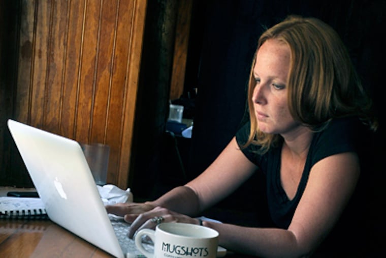 Author Carrie Hagen at work in a coffeehouse near home. "We Is Got Him," her first book, focuses on the 19th-century abduction of a Germantown boy. (Tom Gralish / Staff Photographer)