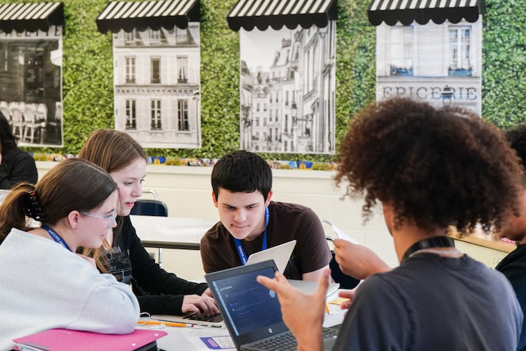 Kayla Clancy, (from left) Kaylee Baker, and Spencer Barrett, chat with an AI program in French class at Gateway Regional High School