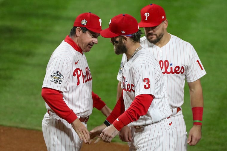 Philadelphia Phillies manager Rob Thomson (left) and Philadelphia Phillies designated hitter Bryce Harper (3) greet during introductions before Game 3.