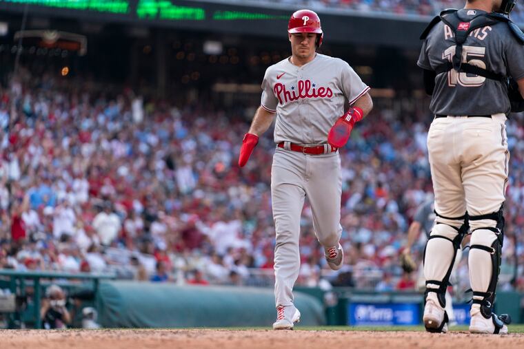 J.T. Realmuto scores one of the Phillies' eight runs during the eighth inning Saturday.