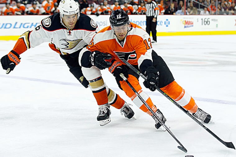 The Flyers' Michael Raffl skates after the puck against the Ducks' Ben Lovejoy. (Yong Kim/Staff Photographer)