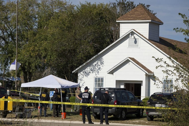 Law enforcement officials investigate a mass shooting at the First Baptist Church in Sutherland Springs, Texas, on Sunday, Nov. 5, 2017.