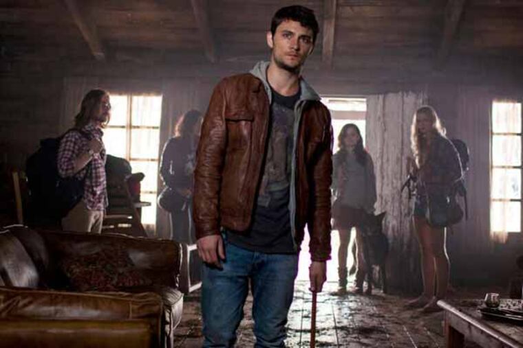 This film image released by Sony-TriStar Pictures shows Shiloh Fernandez, center, in a scene from "Evil Dead." (AP Photo/ Sony-TriStar Pictures, Kirsty Griffin)
