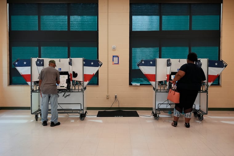 People vote at a polling place in a primary election Thursday, Aug. 6, 2026, in Memphis, Tenn. Democratic turnout for House primaries in Shelby County surged to the highest level in a decade.