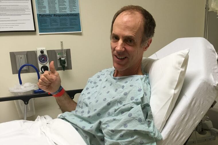 Reporter Tom Avril gives a thumbs-up before his colonoscopy at Holy Redeemer Healthcare’s ambulatory surgery center.