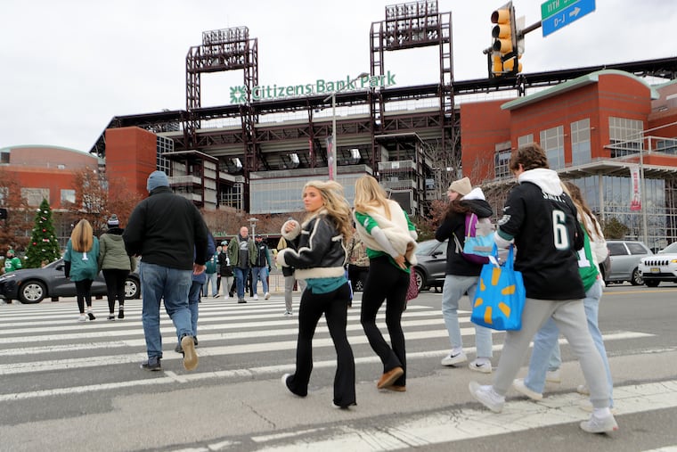 Eagles fans cross Pattison Avenue in front of Citizens Bank Park on Sunday.