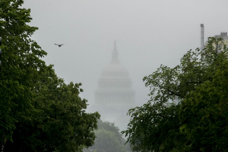 In this May file photo, the Dome of the U.S. Capitol Building is visible through heavy fog in Washington. With COVID-19 cases hitting alarming new highs and a grim rising death toll, the pandemic's devastating cycle is happening all over again, leaving Congress little choice but to engineer another costly rescue.