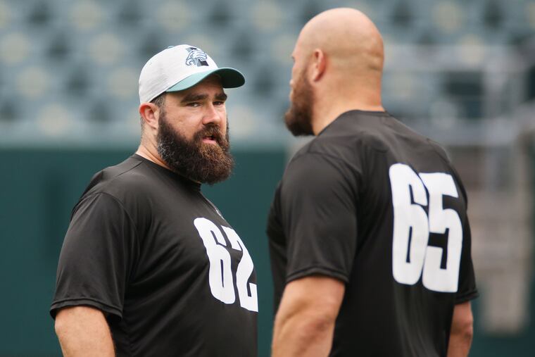 Eagles center Jason Kelce (62) talks with tackle Lane Johnson (65) during practice at Lincoln Financial Field in South Philadelphia on Friday, June 4, 2021.