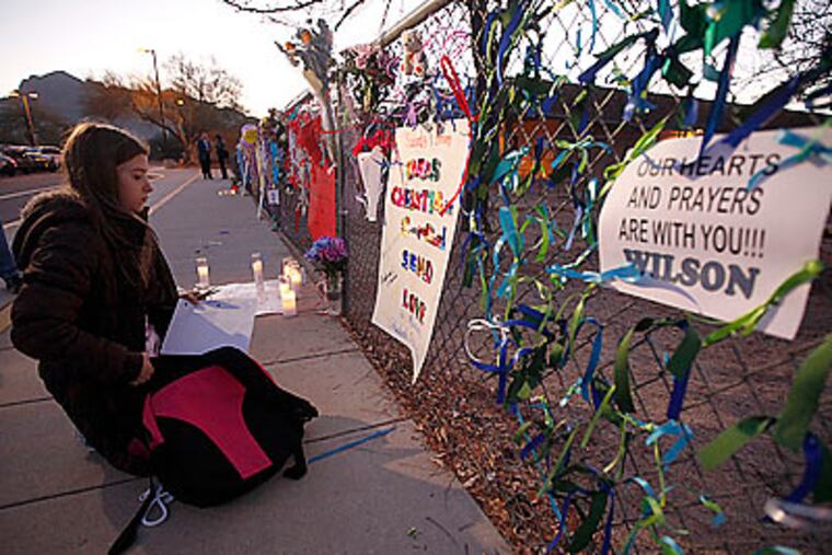 A makeshift memorial has risen near the elementary school that Christina Taylor Green attended. (Chris Carlson/AP)
