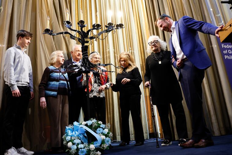Holocaust survivors and family members light candles during the 60th Annual Holocaust Remembrance Ceremony at Temple Beth Zion-Beth Israel near Rittenhouse Square on Sunday.