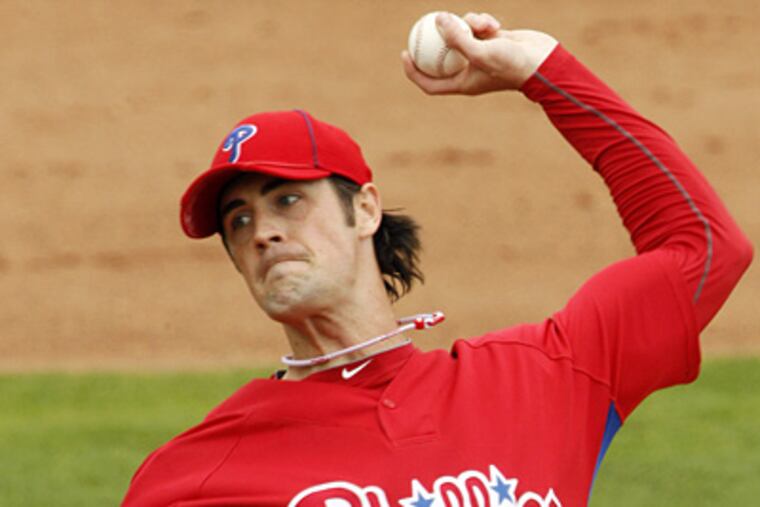 Cole Hamels throws in the second inning of the Phillies' 9-7 win over the Yankees yesterday. (AP Photo/Gene J. Puskar)