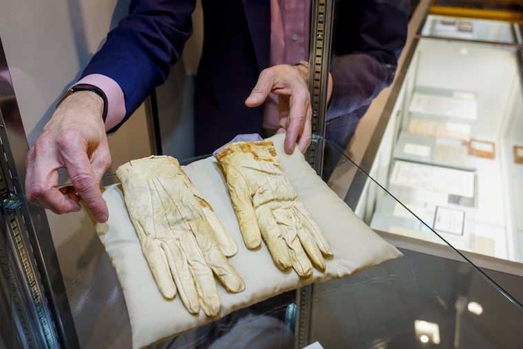 Darren Winston, senior vice president of books and manuscripts, with Abraham Lincoln's gloves at Freeman’s-Hindman on Wednesday, April 23, 2025.