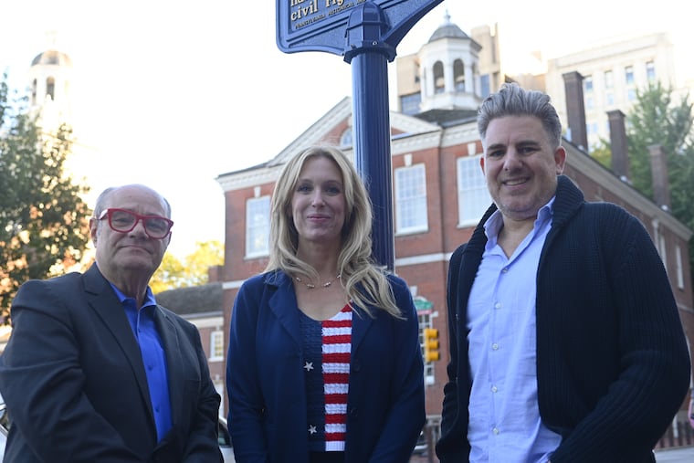 Mark Segal, founder and publisher of Philadelphia Gay News, Maita Soukup, vice president experience and engagement of the Philadelphia Visitors Center, and Neil Frauenglass, chief marketing officer of Visit Philadelphia, at the LGBTQ Historic Marker near Independence Mall, on Oct. 9, 2025.