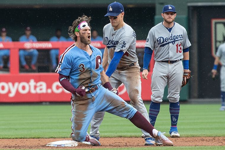 Bryce Harper, wearing a bandanna depicting the Phanatic’s eyes, exults after his game-tying hit in the seventh inning