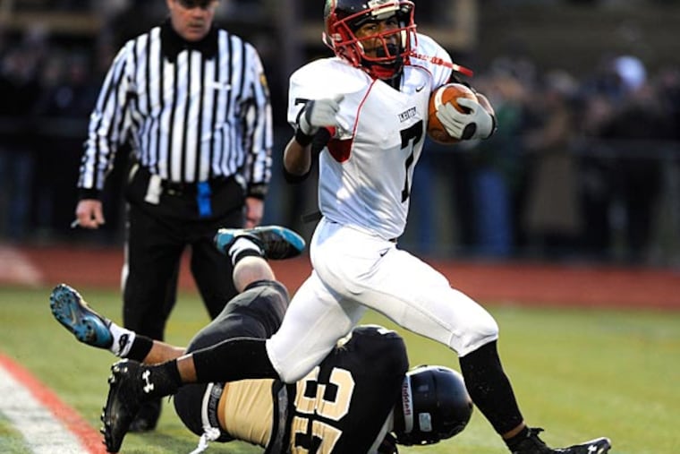 Imhotep Charter's Tyliek Raynor glides into the endzone scoring a
touchdown past Berks Catholic's Chris Warren (35) in the fourth
quarter of the PIAA state Class AA football semifinal game Saturday,
Dec 7, 2013 in Shillington, Pa. Imhotep Charter defetaed Berks
Catholic 20-0. (Philadelphia Inquirer/Bradley C Bower)