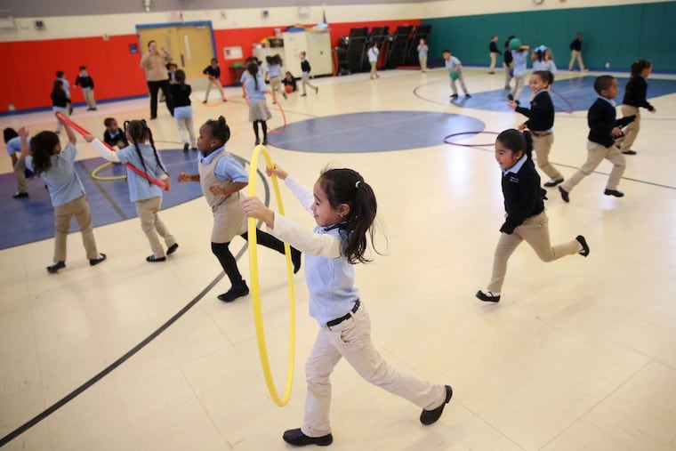 Kindergarten students run around during recess in the gymnasium at Camden’s Pride Charter School in Camden, N.J., on Wednesday.