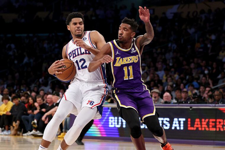 Tobias Harris (12) drives against the Los Angeles Lakers' Malik Monk during the first half at Crypto.com Arena.