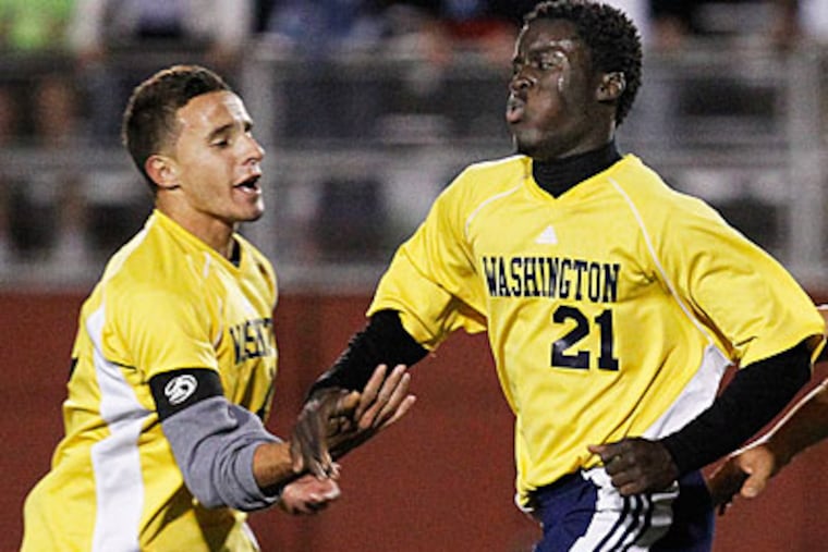 Washington's Wilo Mimbar, right, celebrates his game-winning goal with Mattheus Schaper. (Ron Cortes/Staff Photographer)