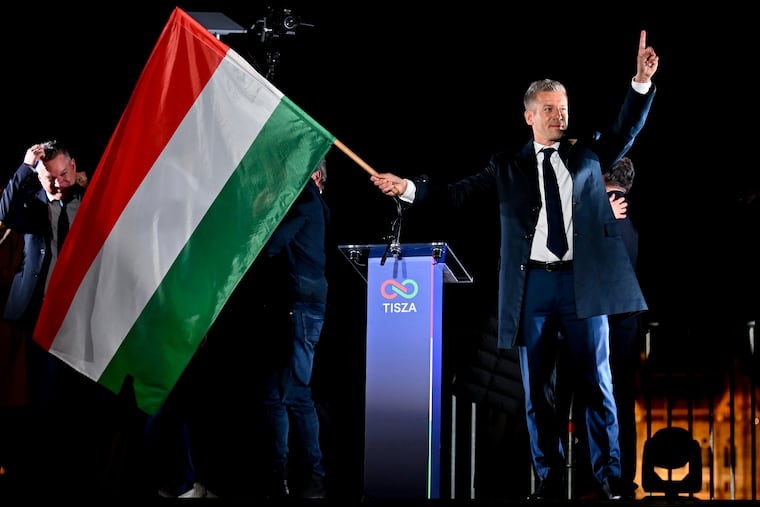 Péter Magyar, leader of the opposition Tisza party, waves the Hungarian flag following the announcement of the partial results of the parliamentary election, in Budapest, Hungary, on Sunday.