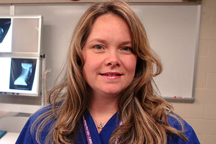 Three years after being laid off, Lisa Marraffino is training for free at Burlington County College for a new career in radiology. Colleges say they expect a jump in such tuition-waiver students. (Tom Gralish/Staff Photographer)