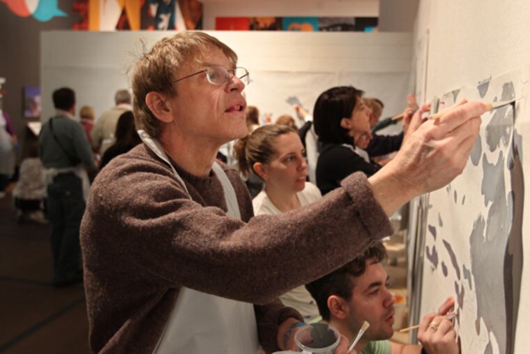 Wayne Roberts works along with a room full of other artists to paint by number the mural sections that will eventually be placed under the Girard Avenue Bridge. The murals are the first to be installed in Philadelphia’s illustrious Fairmount Park. (MICHAEL BRYANT/Staff Photographer)