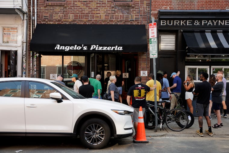 People wait for their orders outside of Angelo’s in Philadelphia.