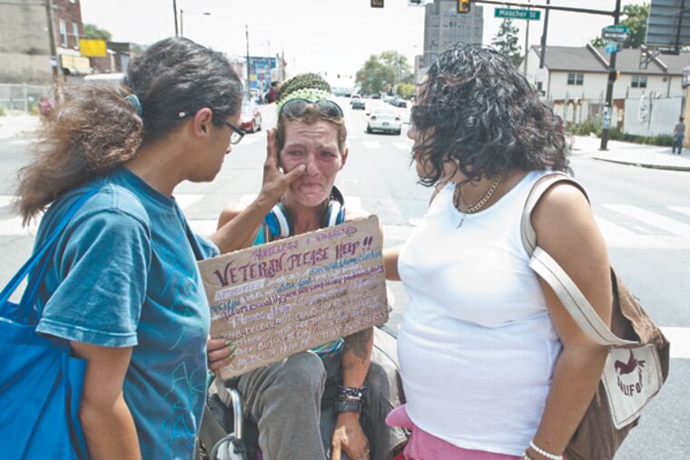 Ilza Padua (left) and Nidia Flores both workers for Prevention Point, wipe tears from Elaine Heyl's eyes as she tells her story of being a homeless vet. (RON TARVER / Staff Photographer)