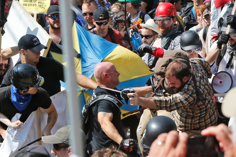 A photo from Aug. 12, 2017, white nationalist demonstrators clash with antiracism counter-protesters at the entrance to Lee Park in Charlottesville, Va.