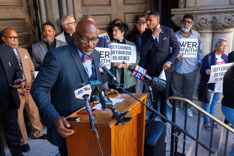 The Rev. Mark Kelly Tyler, pastor of Mother Bethel AME Church, speaks during a news conference with POWER Interfaith, a multiracial coalition. Members gathered on front steps of Mother Bethel on Tuesday.