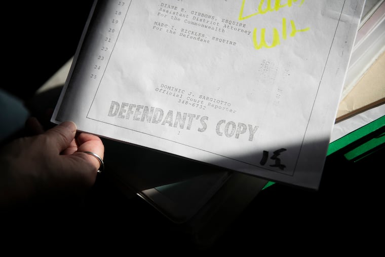 Karen Brookins, wife of John Brookins, goes through case files in her Levittown home. She had hoped for his release by commutation, but the Board of Pardons rejected the application.