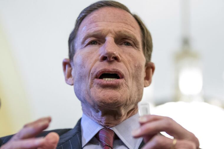 Sen. Richard Blumenthal, D-Conn. holds a thumb drive during a news conference on Capitol Hill in Washington in February.