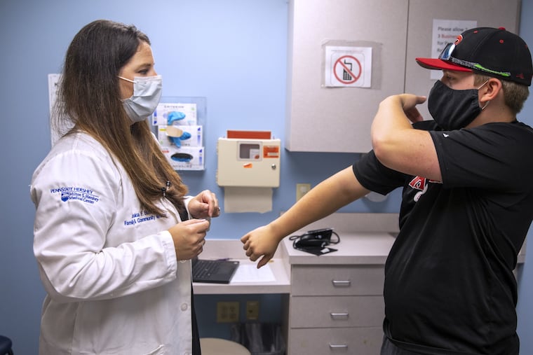 Jessica Butts, a family and sports medicine doctor with Penn State Health, discusses injuries with patient Joshua Hicklin.