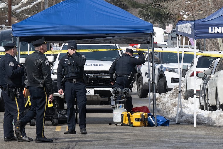 Police investigate the scene of a shooting near the Edgehill Court apartment complex on Wednesday where a man was shot by police following an exchange of gunfire.