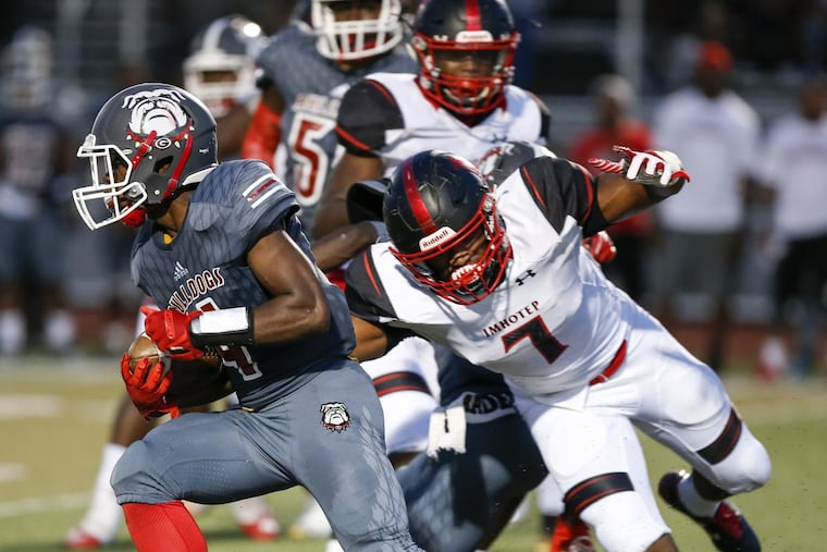 Omar Speights (right) tries to chase down a Simon Gratz ballcarrier in Imhotep Charter’s 40-21 victory last season.