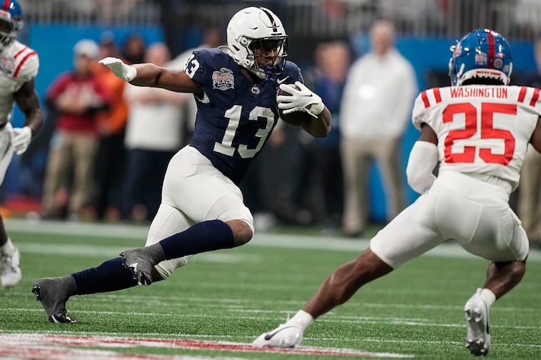 Penn State running back Kaytron Allen (13) runs near Mississippi safety Trey Washington (25) during the first half of the Peach Bowl on Dec. 30, 2023.