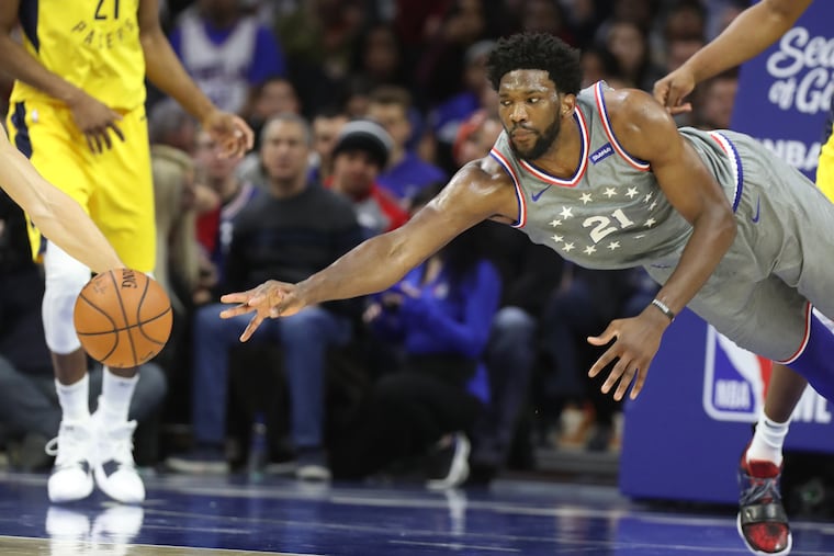 Joel Embiid of the Sixers dives for the ball after it was deflected away by the Pacers during the 2nd half at the Wells Fargo Center on Dec. 14, 2018.