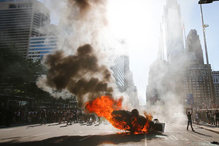 Smoke rises from a Philadelphia police cruiser in Center City during the Justice for George Floyd Philadelphia Protest on May 30.