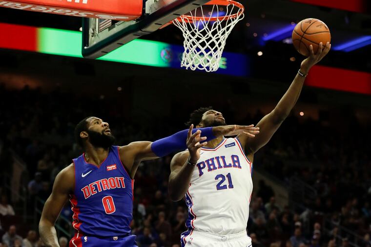Sixers center Joel Embiid is averaging 29 points in six head-to-head matchups against Andre Drummond (left).