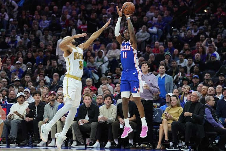 Sixers' Justin Edwards (right) finished with a team-high 22 points against Boston.