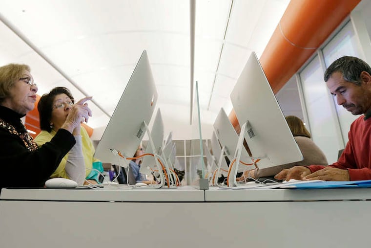Caroline Ramirez and Sam Martinez use computers at BiblioTech, a first-of-its-kind digital public library in San Antonio. Bexar County's BibiloTech is believed to be the nation's only bookless public library.