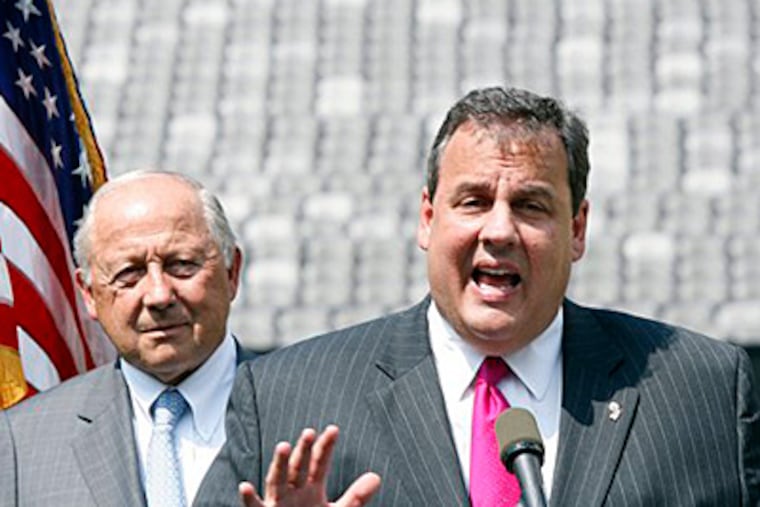 Gov. Christie with Jon F. Hanson, whose panel reviewed the state's gambling, entertainment, and sports industries. (Mel Evans / Staff)