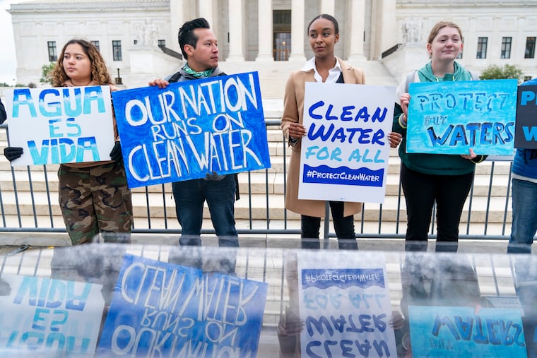 Supporters of the Clean Water Act demonstrate outside the Supreme Court, Oct. 3, 2022, in Washington, as the court begins arguments in Sackett v. Environmental Protection Agency.