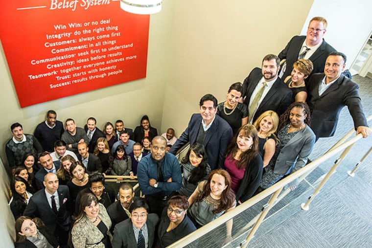 The employees of Keller Williams Realty in their Philadelphia office. (Colin Kerrigan / Philly.com)
