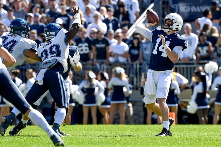 Penn State quarterback Sean Clifford (14) throws a first-quarter touchdown pass to wide receiver Jahan Dotson (5) while being pressured by Villanova linebacker Amin Black (29)/