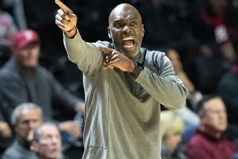 Temple coach Aaron McKie shares instruction with his players during a game at the Liacouras Center.